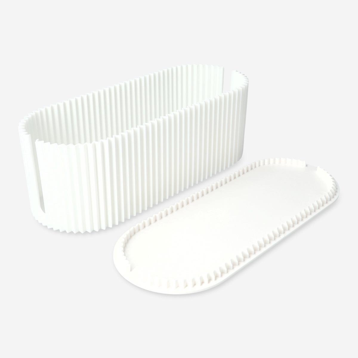 White ribbed plastic box cable hider