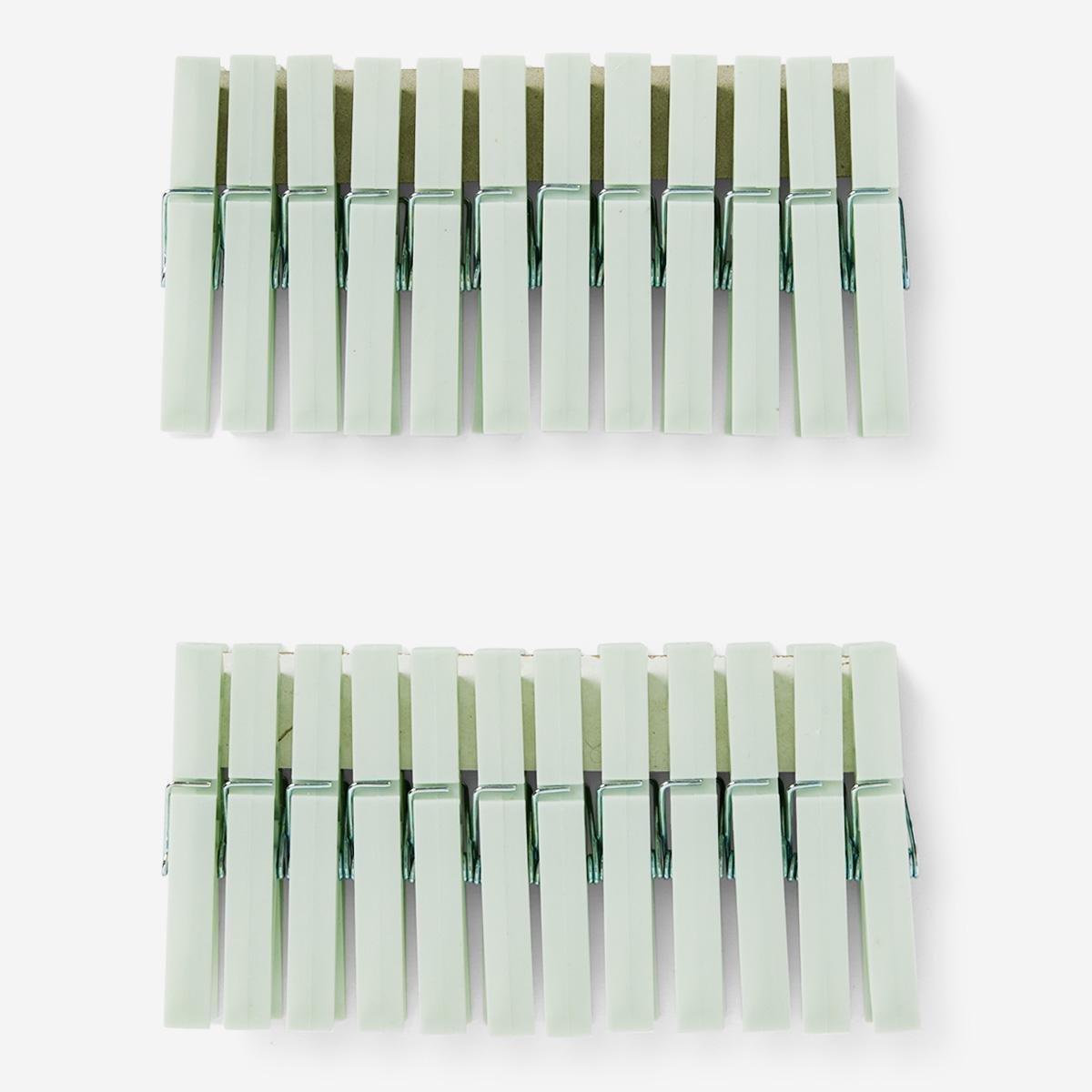 Green clothes pegs