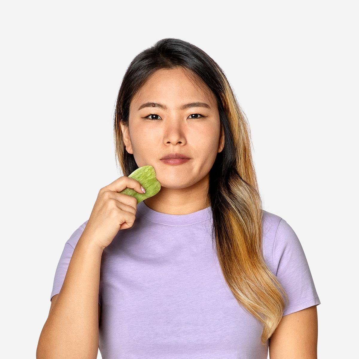 Green gua sha tool. natural stone