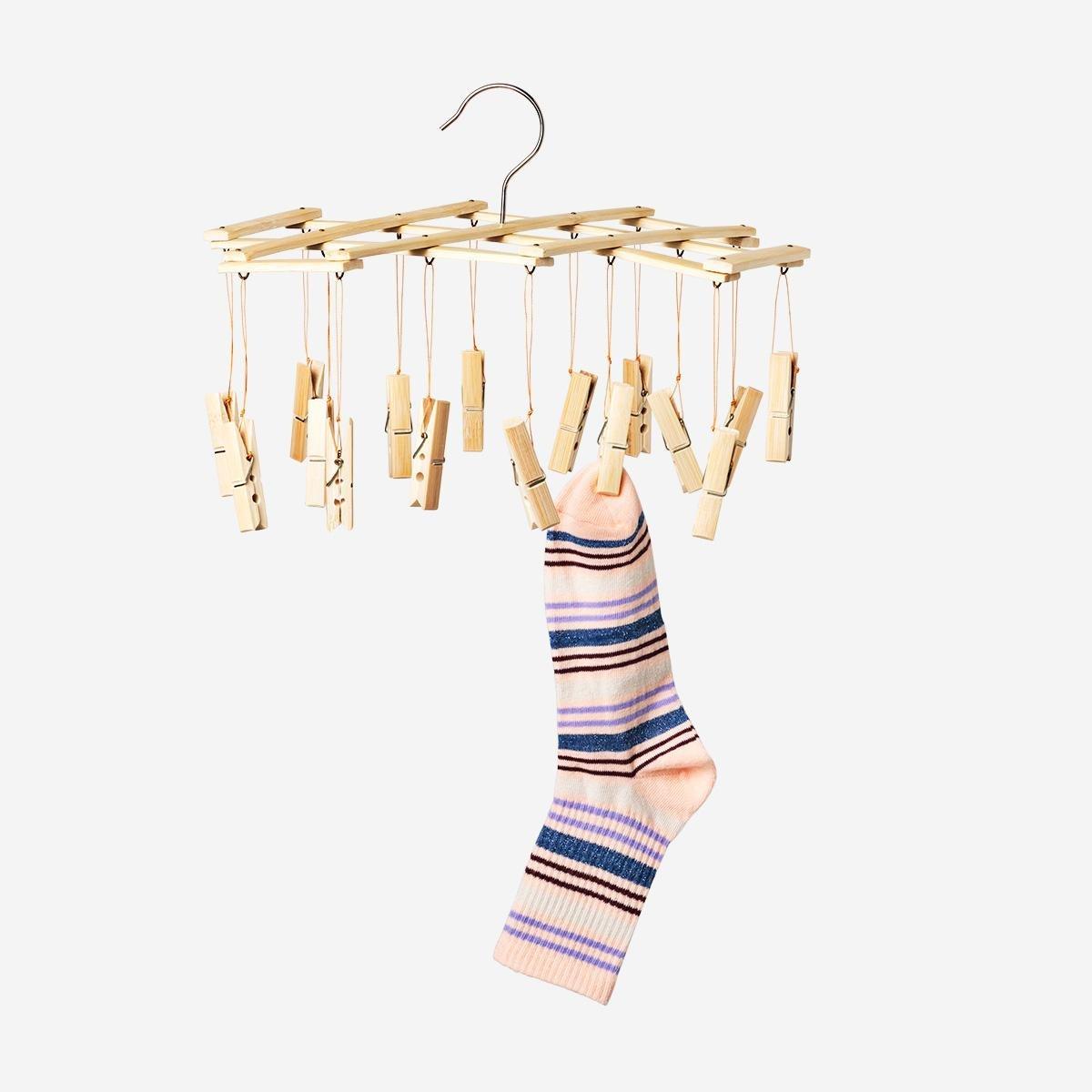 Beige hanging dryer with pegs