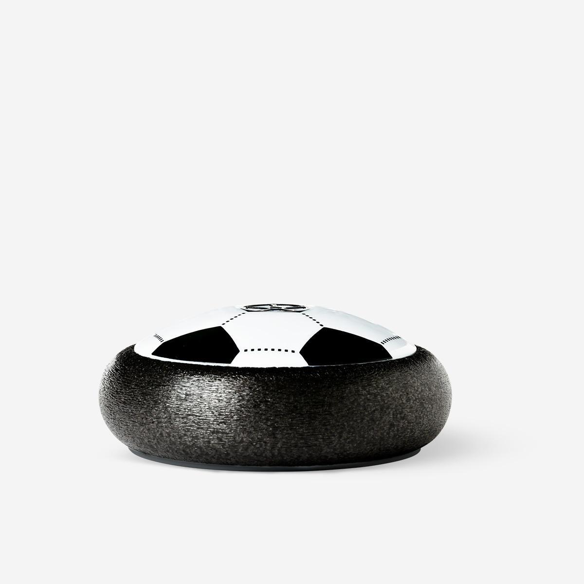 Black floating soccer ball.