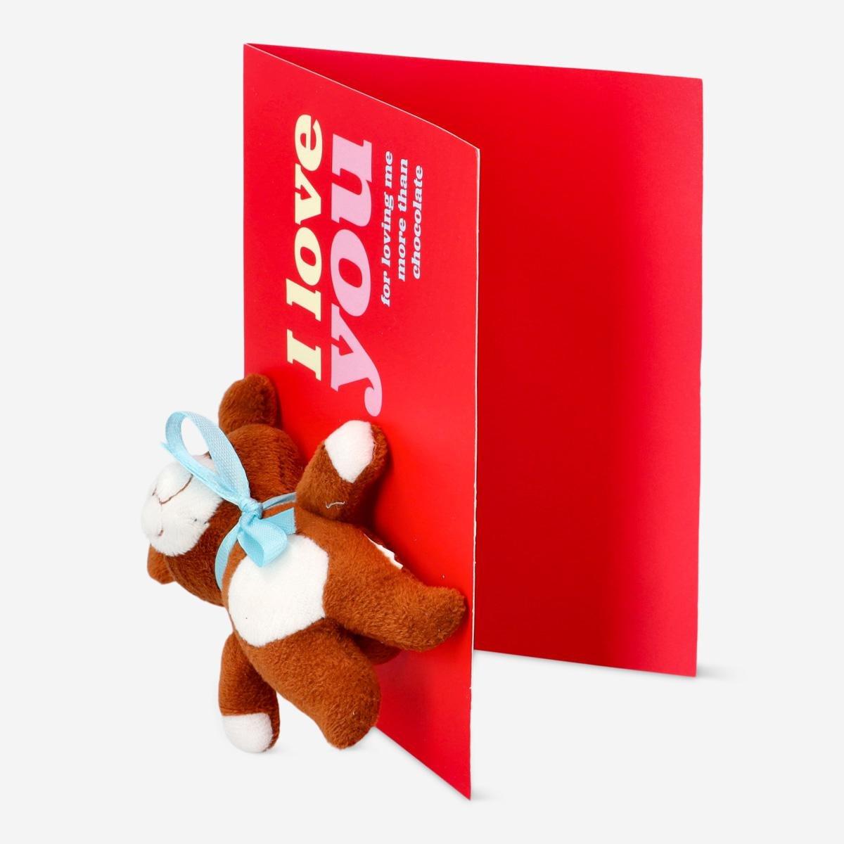 Red cuddly bear with card