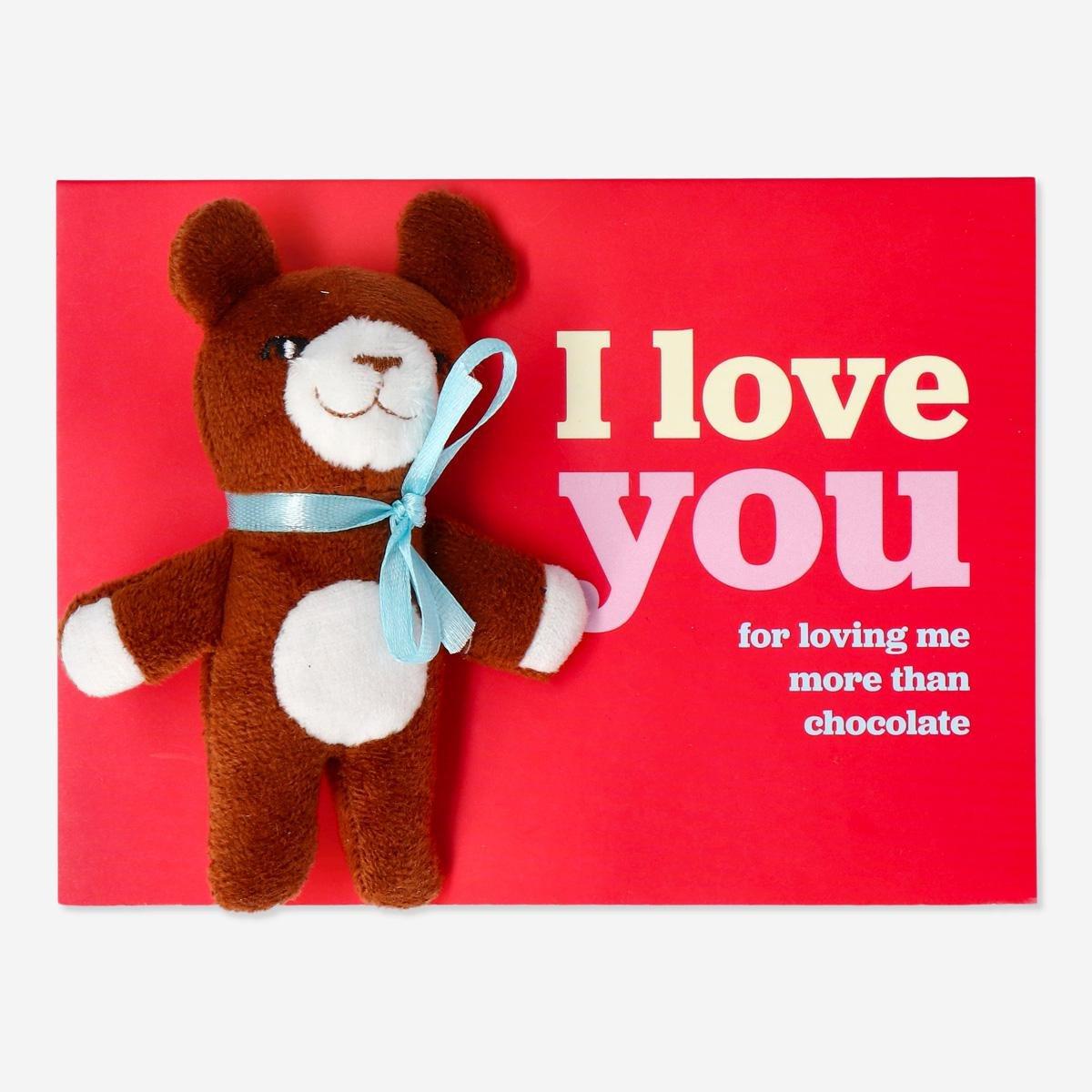 Red cuddly bear with card