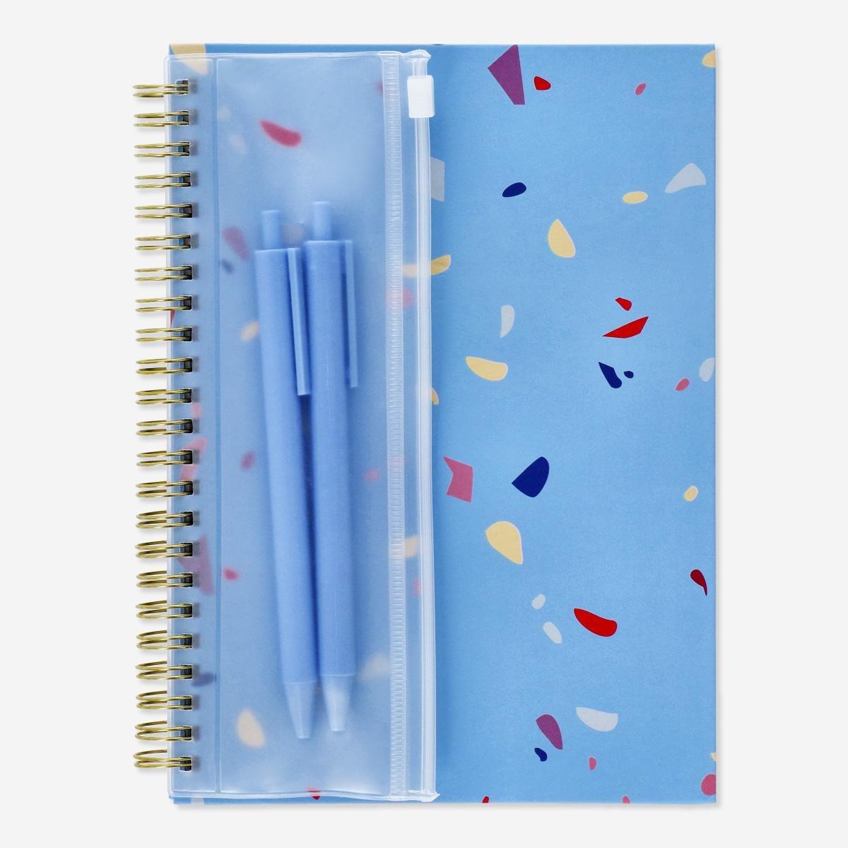 Blue notebook with writing utensils. a5