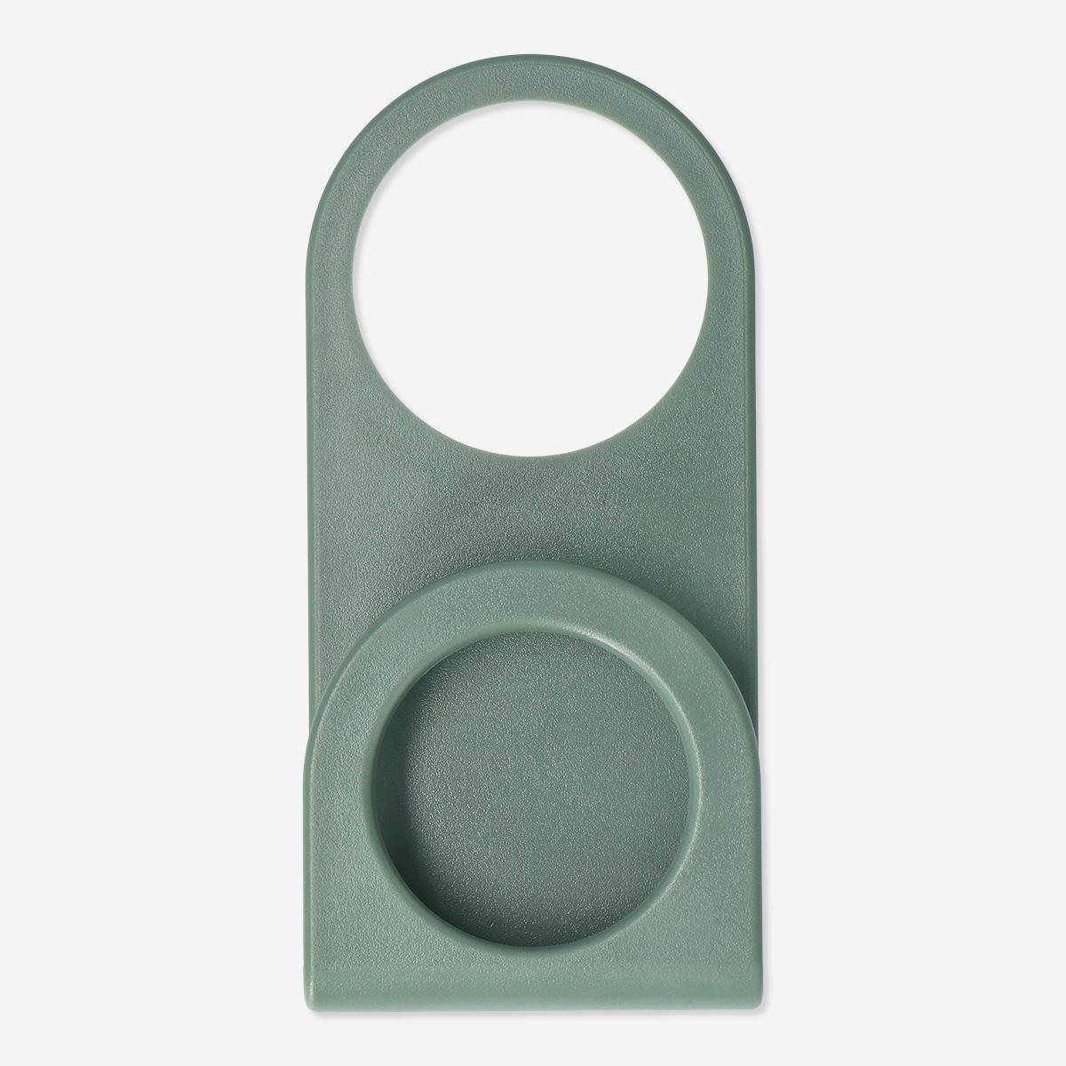 Green wall socket phone holder