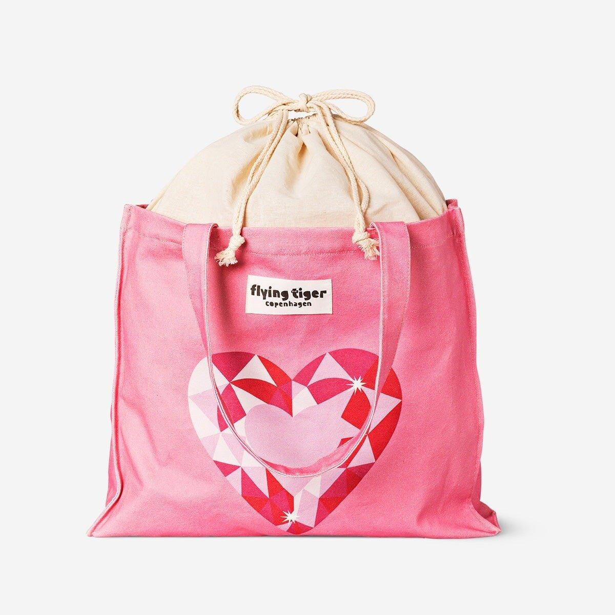 Pink tote bag with drawstring closure